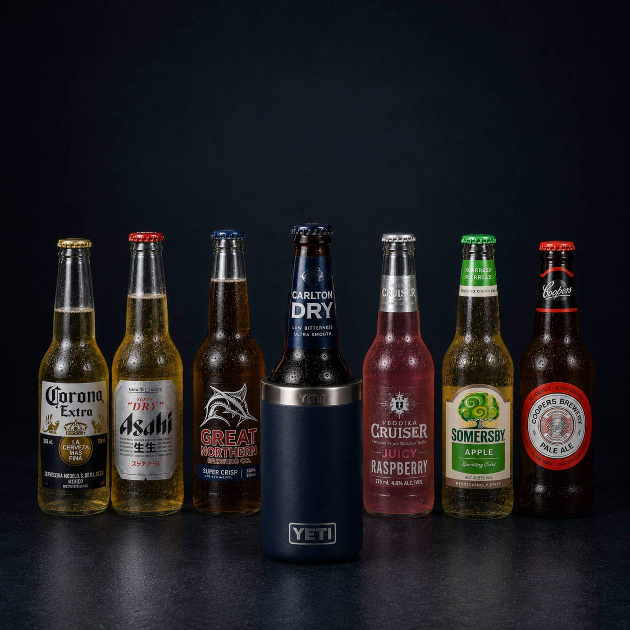 Seven compatible bottles displayed in a row around a navy YETI Rambler Colster 375ml can insulator — Corona Extra, Asahi Super Dry, Great Northern, Carlton Dry, Vodka Cruiser Juicy Raspberry, Somersby Apple Cider, and Coopers Pale Ale — showcasing the full range of bottles supported by the TOPA FitSeal adapter insert.
